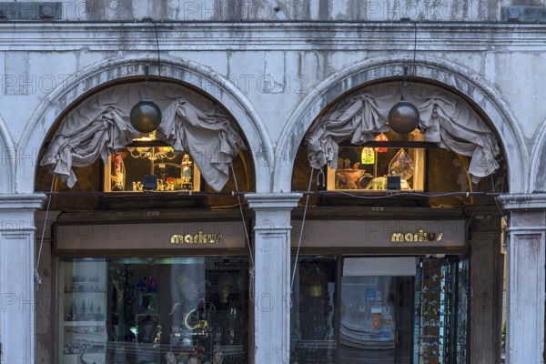 Shops under the arcades of authorized offices in the morning, Venice, Veneto, Italy