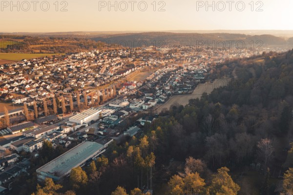 Panoramic view of a town adjacent to dense forest under evening sun, Aidlingen, Böblingen District, Germany