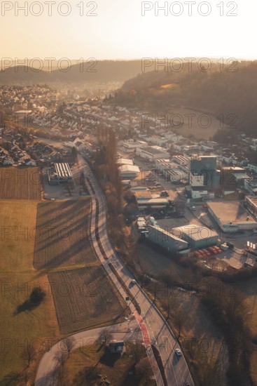 Urban and industrial zones alongside fields and hills in sunset light, Aidlingen, Böblingen District, Germany