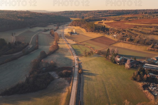 Fields and a road extending through a rural landscape under sunny skies, Aidlingen, Böblingen District, Germany