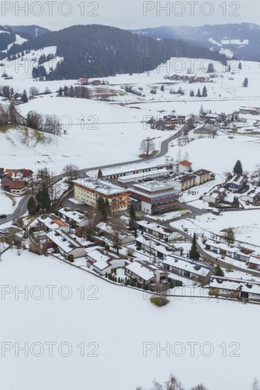 A small village in a snowy landscape with clearly visible roads and buildings, specialist clinic for psychosomatics and psychotherapy, Hochgrat Clinic, Stiefenhofen, Bavaria, Germany
