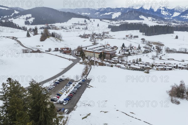 Snowy mountain village surrounded by hills and roads from a bird's eye view, specialist clinic for psychosomatics and psychotherapy, Hochgrat Clinic, Stiefenhofen, Bavaria, Germany