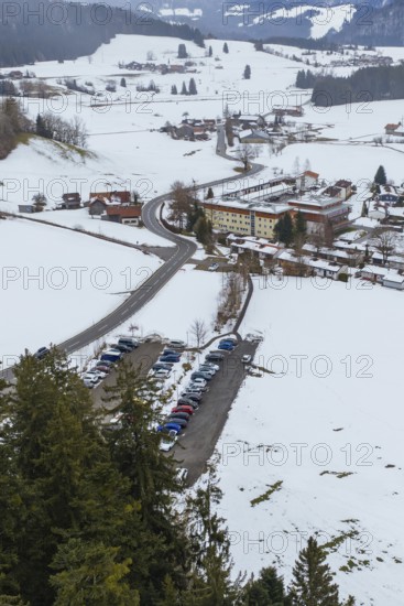 Snowy village with parking lots and picturesque mountains viewed from afar, specialist clinic for psychosomatics and psychotherapy, Hochgrat Clinic, Stiefenhofen, Bavaria, Germany