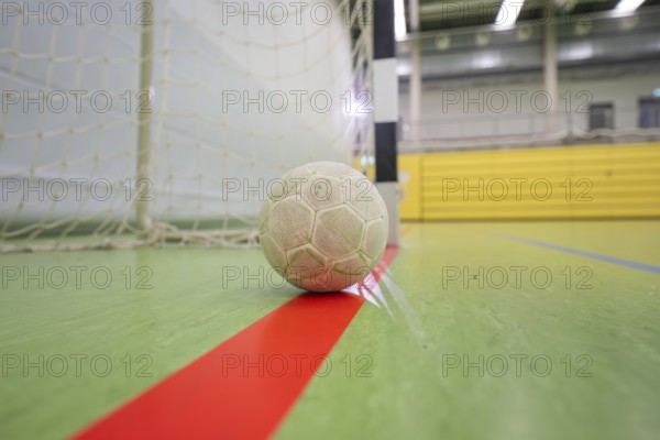 A handball is resting on a red stripe in a sports hall near the goal, Handball, Calw, Germany