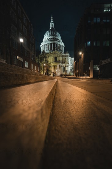 Night view of St. Paul's Cathedral from a quiet street with lights, London, United Kingdom