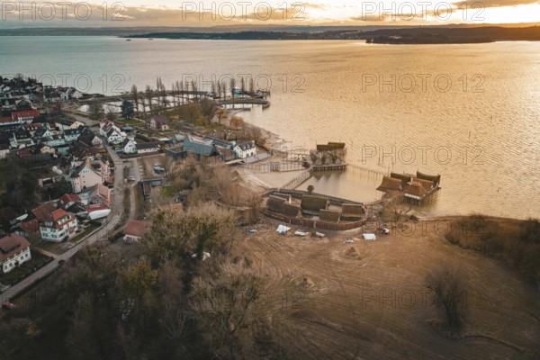 Panorama of a village with stilt houses on the lakeside at sunset, captured in warm light, stilt houses Unteruhldingen, Bodenseekreis, Germany