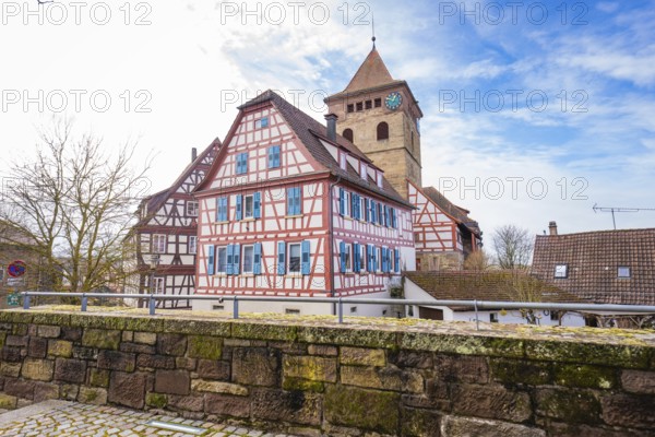 View of half-timbered houses and church tower under blue sky, Ötisheim, Enzkreis, Germany