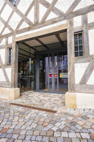 Entrance of a charming half-timbered house with glass front and cobblestones in traditional construction, Ötisheim, Enzkreis, Germany