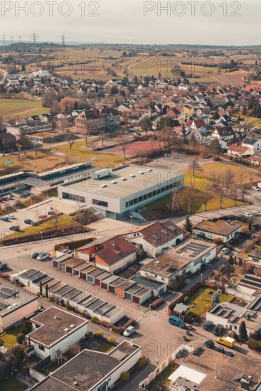 Residential area in a city surrounded by fields and trees seen from the air, Ötisheim, Enzkreis, Germany