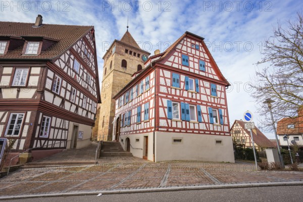 Half-timbered houses and church tower on a paved road in a historic setting, Ötisheim, Enzkreis, Germany