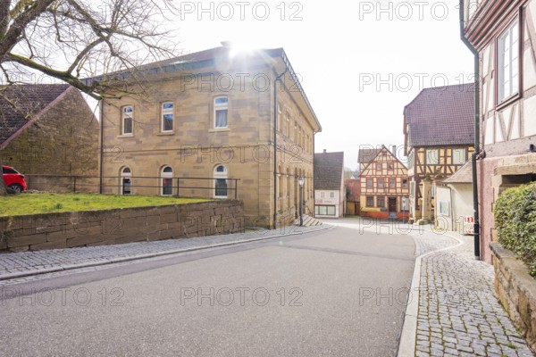 Street scene in the old town with various historic buildings and weak sun, Ötisheim, Enzkreis, Germany