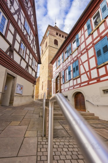Narrow alley with half-timbered houses and view of church tower, traditional atmosphere, Ötisheim, Enzkreis, Germany
