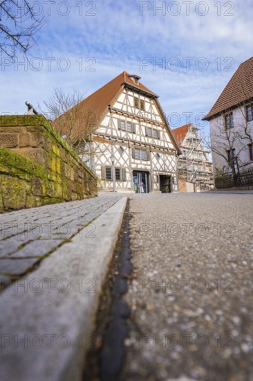 Street scene with traditional half-timbered house and tiled roof under sky, Ötisheim, Enzkreis, Germany