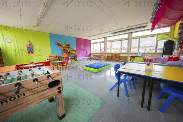 Cheerful playroom in kindergarten with table football, colorful walls and bright windows, homework supervision, Schlehengäu Grund Schule Gechingen, Calw district, Germany