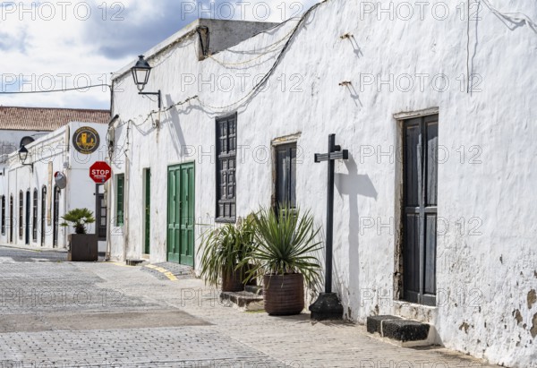 Typical white houses with colored doors and windows in an alley, Teguise, Lanzarote, Canary Islands, Spain