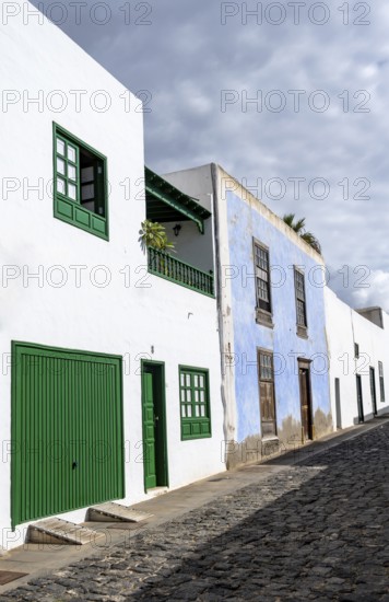 Typical white houses with colored doors and windows in an alley, Teguise, Lanzarote, Canary Islands, Spain