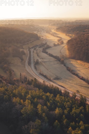View of a valley with roads and forest in the soft light of the setting sun, quiet landscape, Gechingen, Calw district, Germany