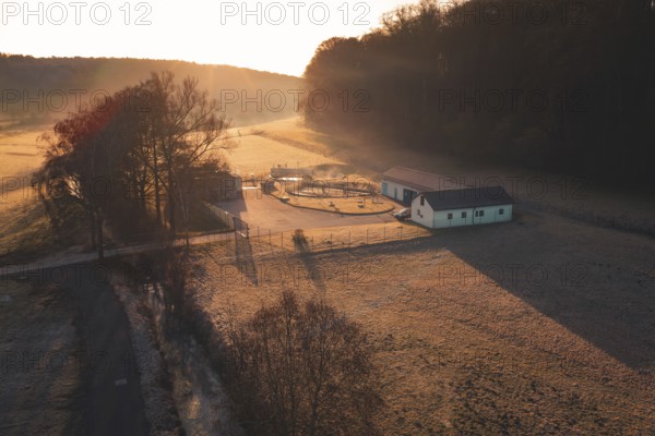 Sewage treatment plant in a meadow surrounded by trees at sunset, rural and peaceful atmosphere, Gechingen, Calw district, Germany