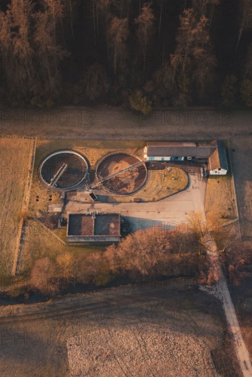 Sewage treatment plant next to a building in an autumnal landscape seen from the air, Gechingen, Calw district, Germany