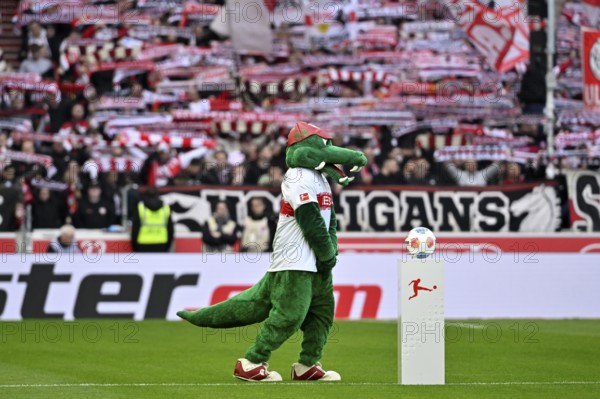 Mascot Fritzle VfB Stuttgart in front of Adidas Derbystar match ball on podium, behind fan block, fans, fan curve, flags, mood, atmospheric Ultras Cannstatt curve VfB Stuttgart soccer Bundesliga, MHPArena, MHP Arena Stuttgart, Baden-Württemberg, Germany