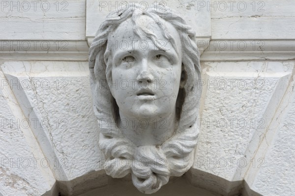 Sculpture of a woman's head above a gate, Venice, Ventien, Italy