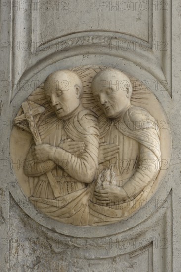 Relief of two clergy at the entrance of a church, Venice, Veneto, Italy