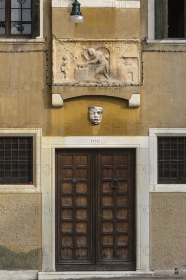 Relief illustration from Greek mythology, Vulcan hardens Cupid's arrows, Venice, Veneto, Italy