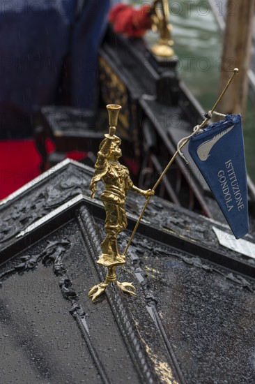 Gold-colored figure on a gondola, Venice, Veneto, Italy