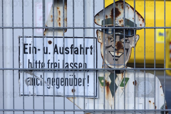 1950s traffic police officer metal sign behind a wire fence, Bavaria, Germany