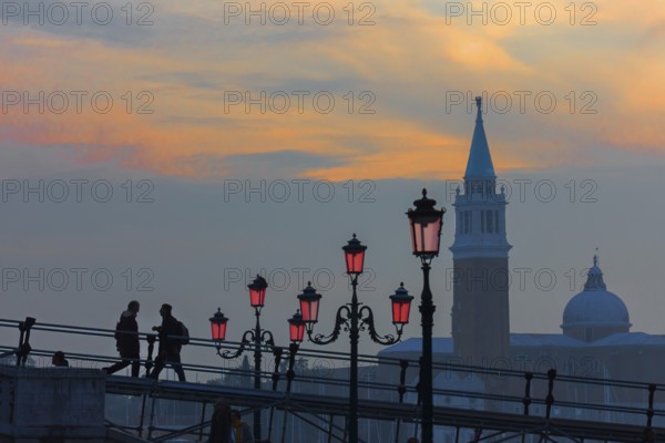 Silhouette of lanterns and San Giorgio Maggiore church at sunset, Venice, Veneto, Italy