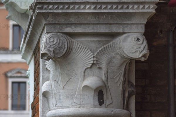 Captain design with fish figures on the arcades of the historic market in Rialto, Venice, Veneto, Italy