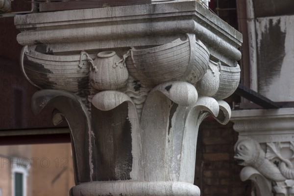 Captain design with fishing boats on the arcades of the historic market in Rialto, Venice, Veneto, Italy