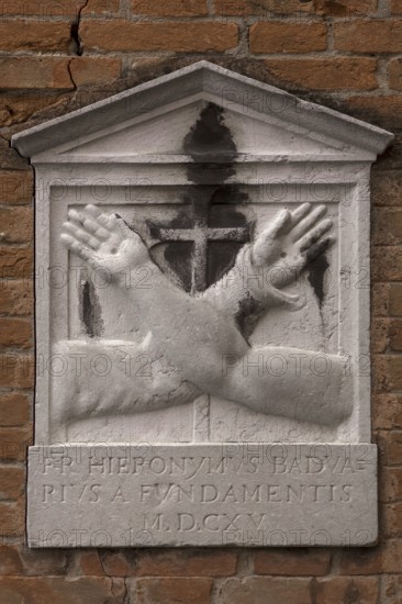 Memorial plaque with crossed hands on a house wall, Venice, Veneto, Italy