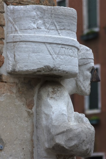 Detail of the marble statue of a merchant family from the 13th and 14th century, Campo dei Mori in the Cannaregio district, Venice, Veneto, in the district of Cannaregio, Venice, Veneto, Italy