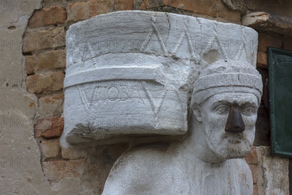 Detail of the marble statue of a merchant family from the 13th and 14th century, Campo dei Mori in the Cannaregio district, Venice, Veneto, in the district of Cannaregio, Venice, Veneto, Italy