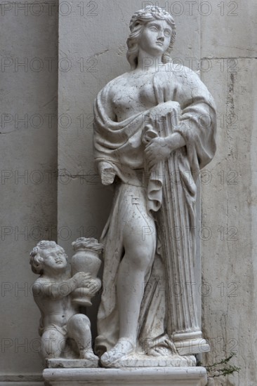 Female sculpture with a column in her arms, Venice, Veneto, Italy