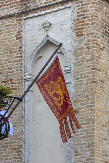 Waving Venetian flag on a balcony, Venice, Veneto, Italy