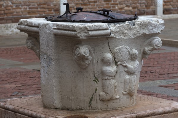 Old fountain with relief design, Venice, Veneto, Italy