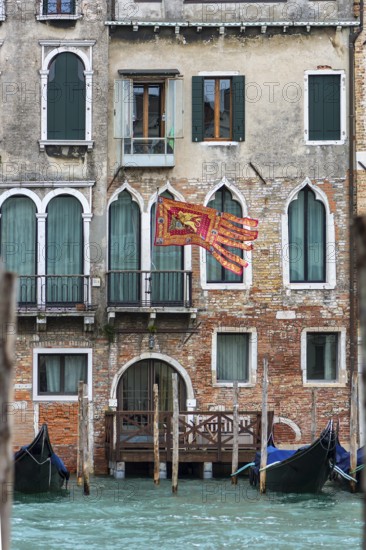 Waving flag of the Republic of Venice on a residential building, Venice, Venice, Italy