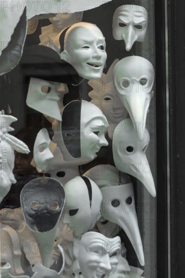 Different carnival masks in white in a shop window, Venice, Veneto, Italy