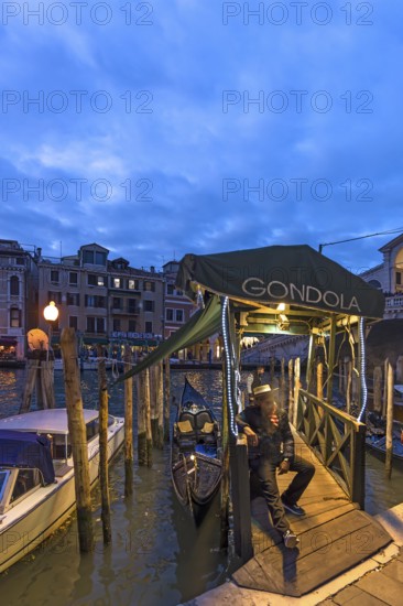 Gondolier waiting for tourists, Venice, Veneto, Italy