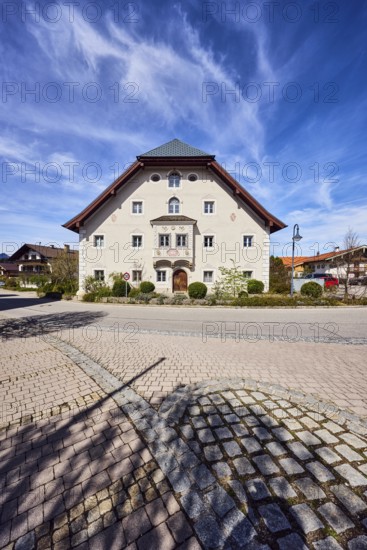 Houses, alpine buildings, general architecture, façade with bay window, windows and façade painting, crippled hipped roof, lantern, blue sky, cirrus clouds, cirrostratus clouds, intersection of Reichenhaller Straße, Schmelzer Straße with Traunsteiner Straße, Inzell, district of Traunstein, Bavaria, Germany