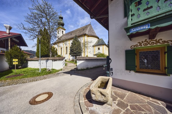 St. Michael church, pump with well trough, building, general development, street sign, wall with passage, stairs, lawn, path, trees, blue sky, cirrus clouds, cirrostratus clouds, Kirchweg, Inzell, district of Traunstein, Bavaria, Germany