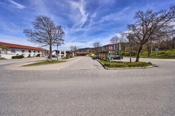 Inzell bus station, parking lot with cars, general architecture, residential buildings, bare winter trees, hilly landscape, coniferous forest, blue sky, cirrus clouds, cirrostratus clouds, Traunsteiner Straße, Inzell, Traunstein district, Bavaria, Germany