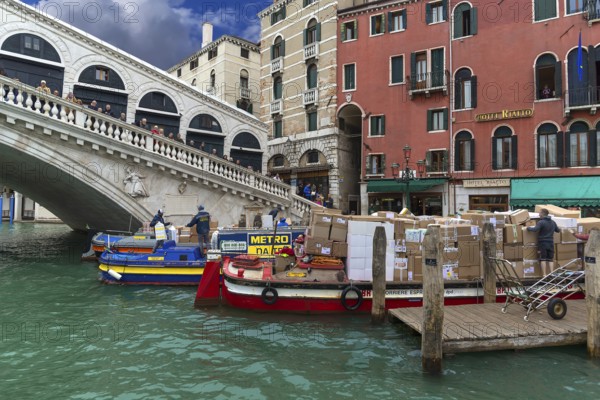 Delivery of parcel mail by ship at the Rialto Bridge, Venice, Veneto, Italy