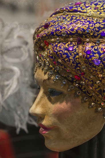 Venetian carnival mask in a shop window, Venice, Veneto, Italy