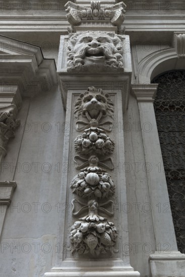 Fruit and animal sculptures on a pillar of a church, Venice, Veneto, Italy