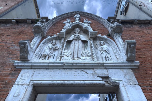 Entrance gate with the mantle Madonna flanked by saints, Venice, Veneto, Italy