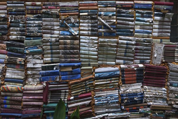 Stacked books after flood damage in a bookstore, Venice, Veneto, Italy