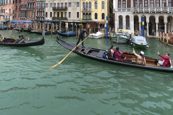 Gondolas with tourists on the Grand Canal, Venice, Veneto, Italy